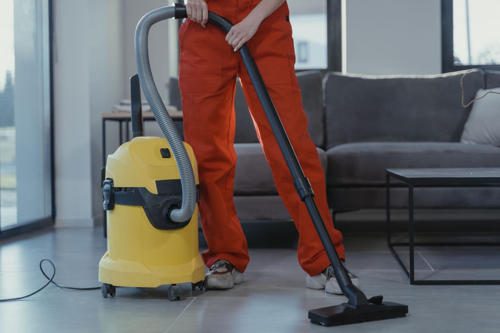 PureSoft Carpet Care technician running a professional extraction vacuum across a tile floor in a Waco-area home